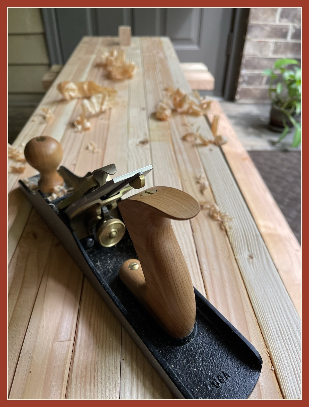 The No. 5 jack plane on the slab, surrounded by curls of shavings.