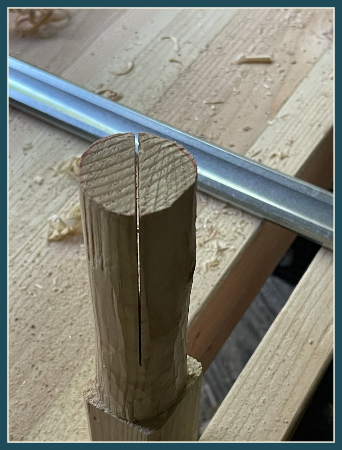Close-up of a round tenon with a saw kerf cut down its center.