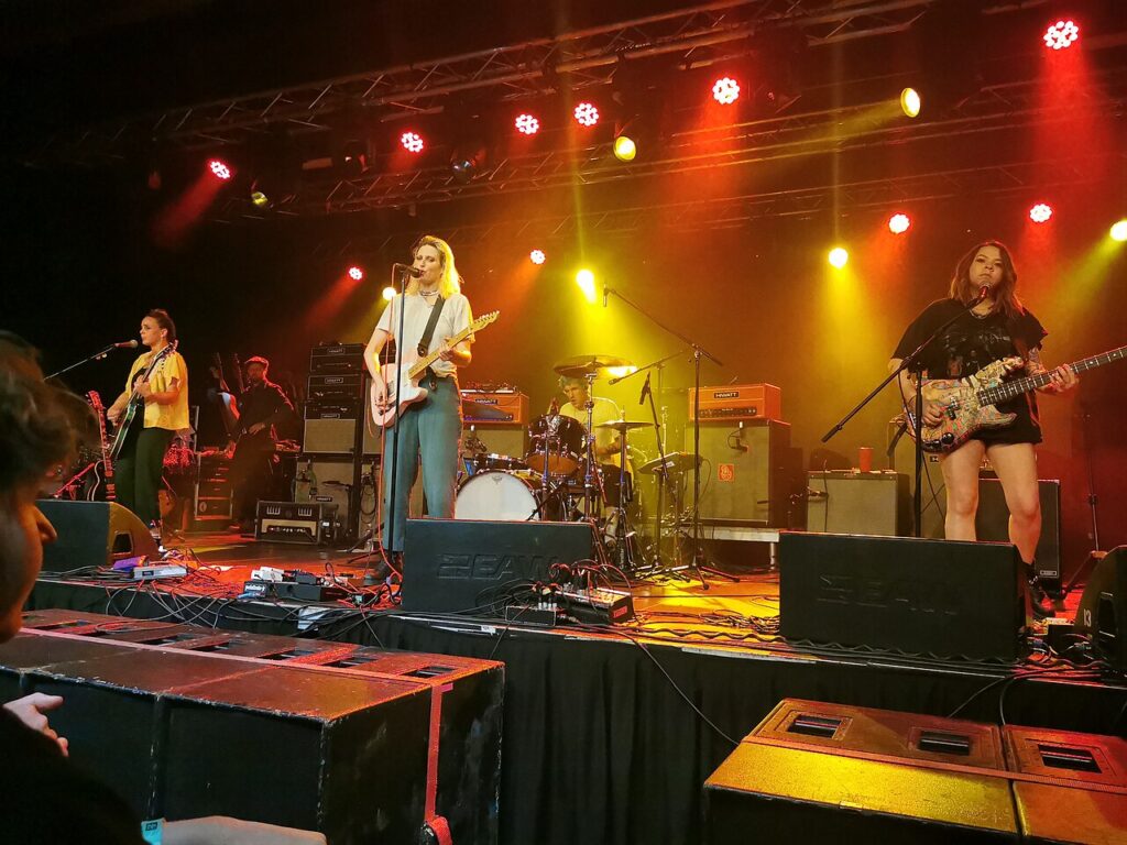 Dead Sara performing under red and yellow stage lights